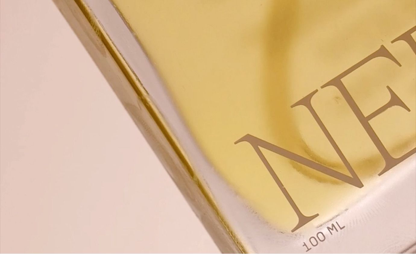 Nerra bottle close-up showing brand typography and golden oil