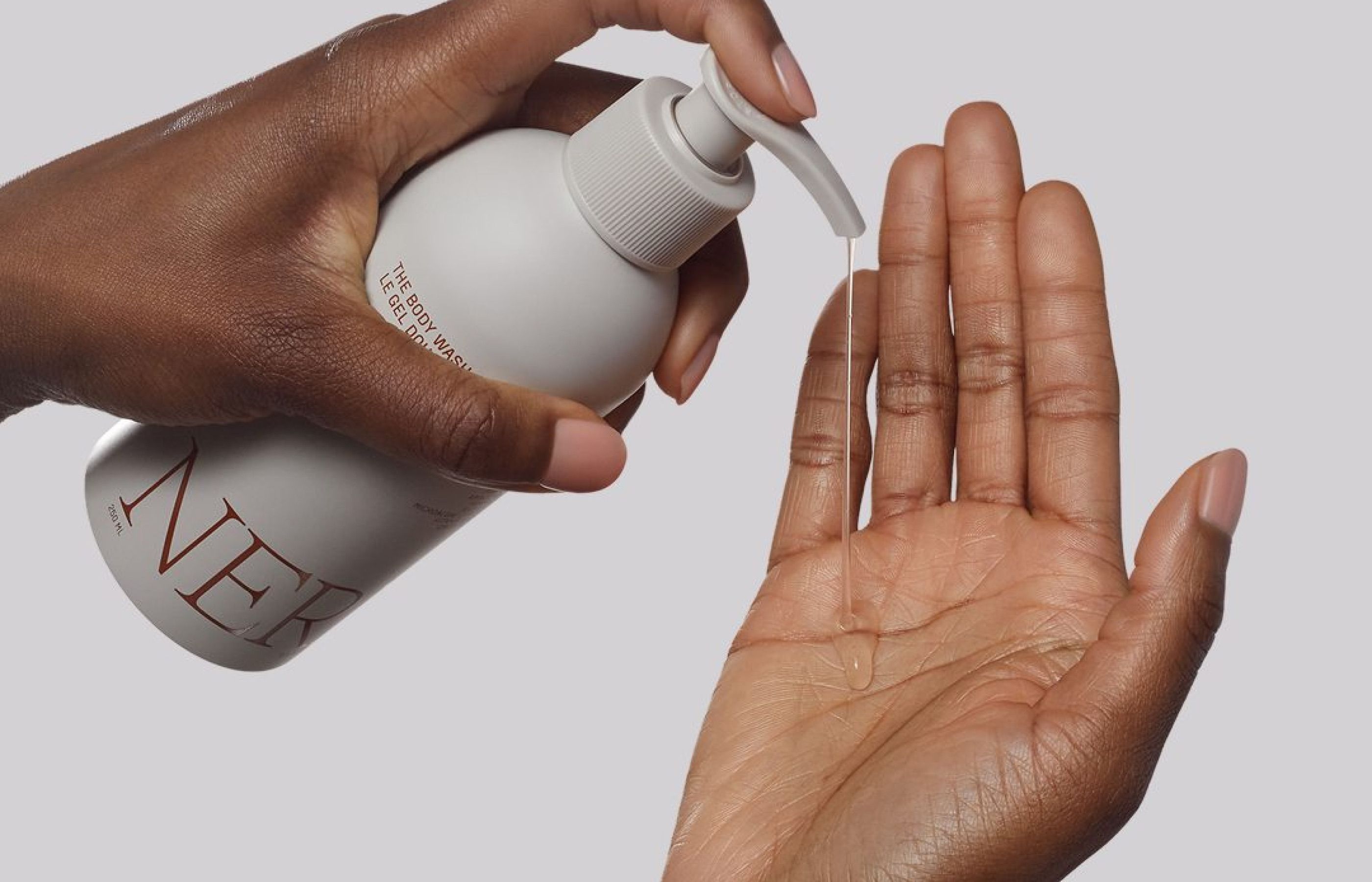 Nerra body wash product being dispensed onto a hand, close-up shot